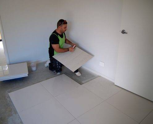 installing floor tiles
